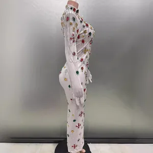 Side view of white rhinestone bodycon dress with tassels and integrated gloves.