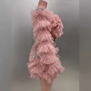 Elegant pink ruffled tulle mini dress with long sleeves and rhinestone accents
