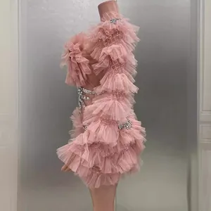 Elegant pink tiered mesh mini dress with rhinestone details, side view studio shot