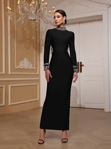 Elegant black bandage evening dress with heavy gemstone embellishments on neck and cuffs