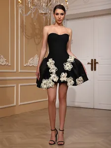 Elegant black strapless bandage mini dress featuring white 3D floral appliques and flared skirt.
