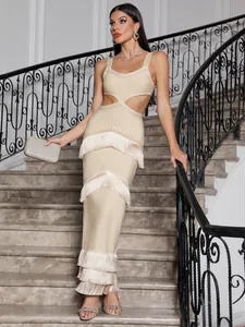 Detail view of a beige bandage maxi dress with tiered fringe and waist cut-outs.