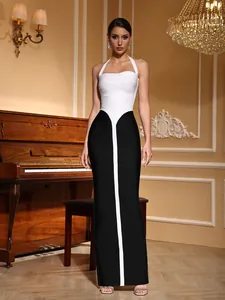 Elegantly styled full-length black and white bandage dress displayed in a luxury interior.