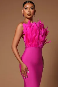 Elegant hot pink strapless midi bandage dress featuring a voluminous feather bust detail.