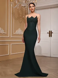 Elegant dark green strapless bandage mermaid evening gown featuring a sequin embellished bodice