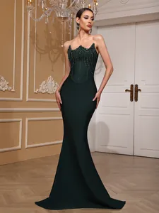 Elegant dark green mermaid evening gown featuring a sequined bodice and floor-length train