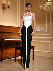 Full-length detail of a black and white halter neck bandage maxi dress worn by a model