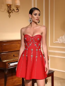 Close-up of red strapless bandage dress with luxury heavy bead embroidery and crystals
