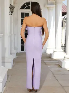 Detailed back view of an elegant purple strapless bandage maxi dress featuring a slit.