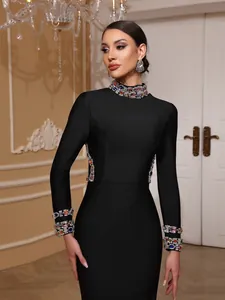Detail of black bandage evening dress with colorful gemstone collar and cuffs. Lux.