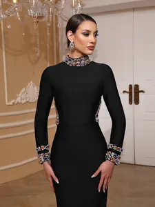 Detailed shot of black long-sleeved evening gown with heavy gemstone collar and cuffs