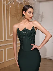 Close-up view of elegant emerald green bandage dress featuring intricate sequin detailing