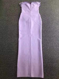 Detailed back view of a lavender strapless bandage dress featuring a long central slit.