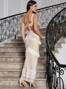Back view detail of beige bandage skirt set with tiered fringe and open back design