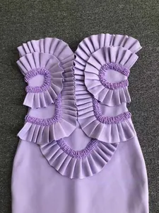 Detailed view of purple strapless bandage dress with intricate ruffles and beaded trim