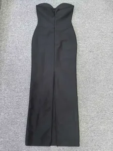Detailed back view of a black strapless mermaid bandage maxi dress with high slit