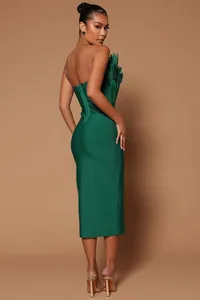 Side view of elegant emerald green strapless bandage dress with luxury feather details