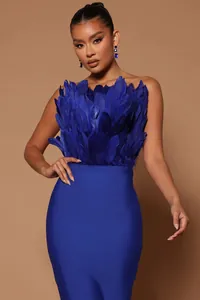 Detailed view of a royal blue strapless bandage midi dress featuring elegant feather trim