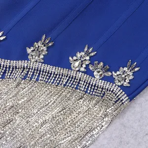 Macro detail of luxury royal blue bandage dress with sparkling silver rhinestone fringe