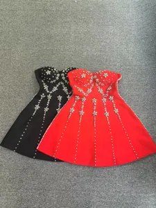 Detailed macro view showing heavy beadwork and floral sequins on red and black bandage dresses