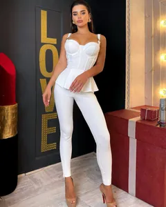 Elegant white knitted two-piece set featuring peplum top with metal buckles and ribbed leggings