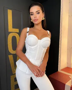 Detailed view of white bandage rib peplum top and matching pants set worn by a model
