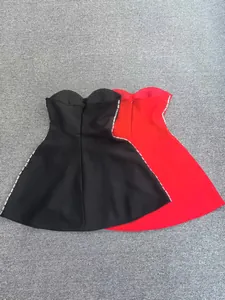 Detail view of red and black strapless bandage dresses with side rhinestone trim