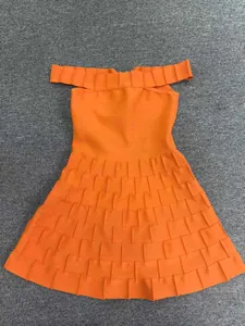 Macro detail of vibrant orange off-the-shoulder bandage dress with tiered A-line ruffled skirt