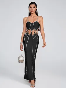 Elegant black bandage maxi dress featuring vertical rhinestone lines and waist cutouts.