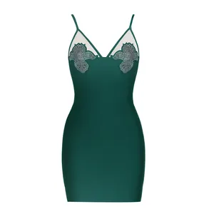 Front detail of dark green bandage dress with sheer mesh and rhinestone accents.