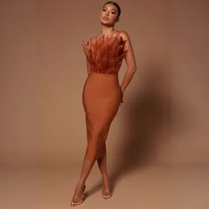 Elegant brown strapless midi bandage dress featuring lush feather bust detail for women.