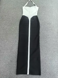 Detailed flat lay view of a black and white bandage halter neck maxi dress for women