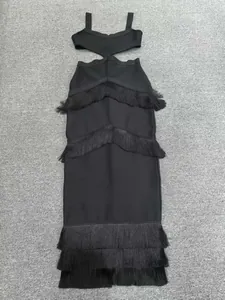 Detailed view of black bandage midi dress with waist cut-outs and tiered fringe