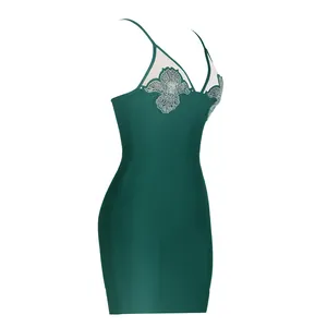 Detail of dark green bandage dress with rhinestone mesh deep V-neck and spaghetti straps.