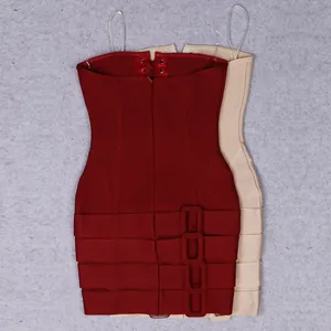 Detail view of burgundy and beige bandage mini dresses with decorative buckles and lace-up back