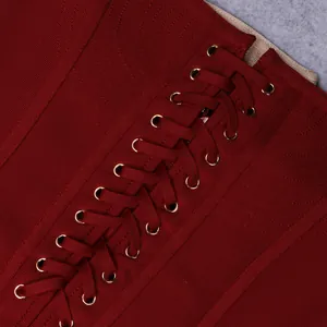 Macro detail of red bandage dress featuring adjustable lace-up front with gold eyelets