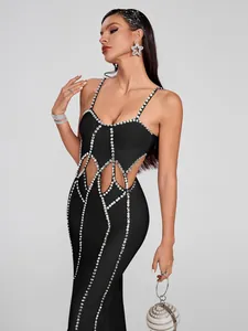 Detail view of a black bandage dress featuring waist cutouts and rhinestone detailing.
