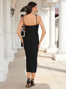 Back view of a black bandage midi dress with rhinestone details for elegant cocktail parties.