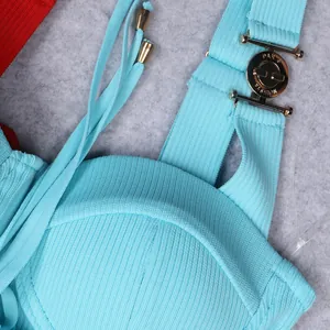 Detail of golden Paris Fashion metal buckle on light blue ribbed knit bandage top