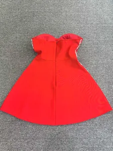 Detail of the back zipper and beaded side panels on this red strapless bandage party dress.