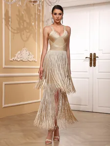 Full-length view of a gold fringe bandage dress on a model in an elegant setting