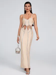 Detail view of a nude bandage maxi dress with vertical rhinestone trim and waist cut-outs