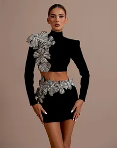 Detail view of black bandage set with luxury rhinestone floral appliques and mini skirt