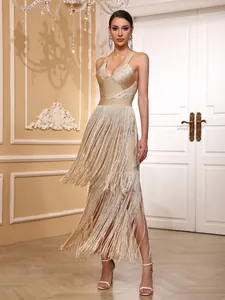 Detailed view of a gold fringe bandage dress with deep V-neck for red carpet.