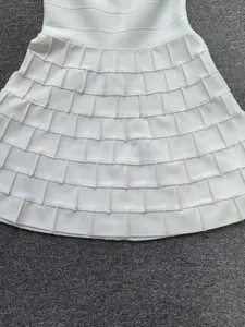 Detail view showing the textured square pattern of a white knitted A-line bandage dress.