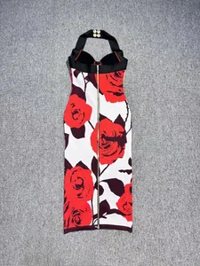 Detailed back view of floral halter bandage dress with red rose print and full gold zipper