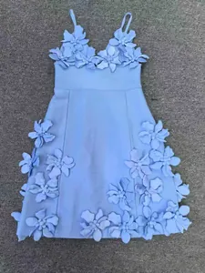 Détail d'une robe bandage bleu clair avec d'élégantes appliques de fleurs 3D chic