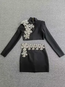 Full view of the black bandage set featuring a high-neck crop top and crystal flower mini skirt.