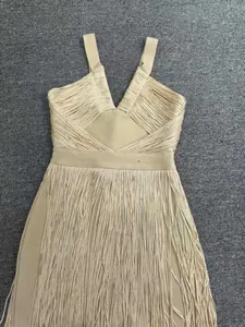 Exquisite detail of a champagne fringe bandage party dress with a deep V-neck design.