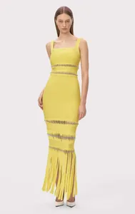 Detail view of yellow bandage evening gown with metallic studs and long fringe hem.